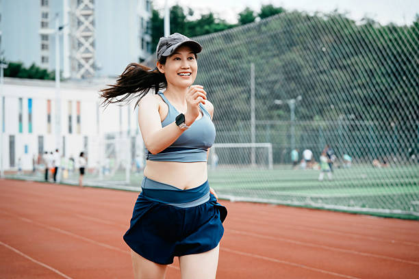 istock Woman Jogging on Running Track 2228131453