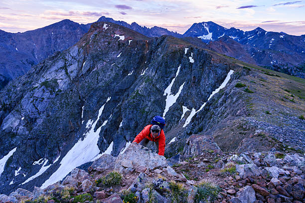 istock Man Scrambling and Hiking Along High Mountain Ridge 2228138664