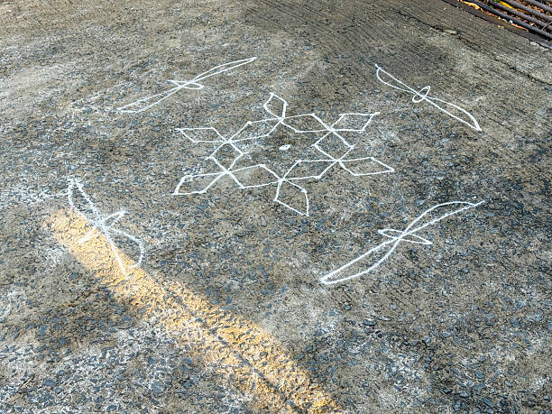 istock A white chalk drawing of a snowflake on a grey concrete floor 2228138817