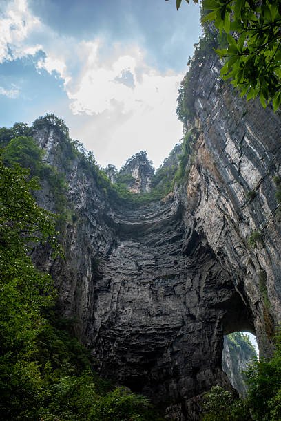 istock Majestic Natural Rock Archway in Lush Forest 2228139019