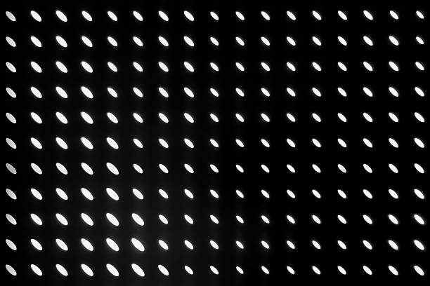 Abstract grid of glowing oval shapes on a black background