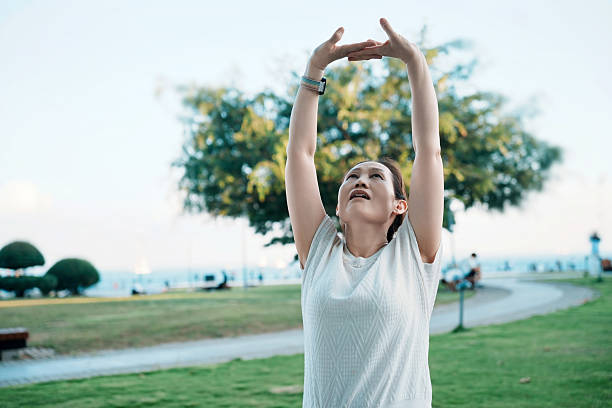 istock Woman Stretching Outdoors in Park 2228141150