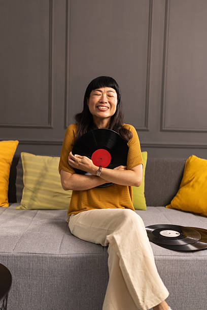 istock Nostalgic woman hugging vinyl records at home 2228141830