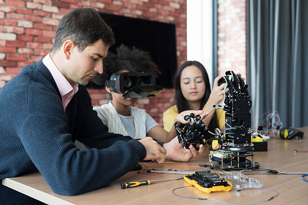 istock Male teacher teaching diverse children training and learning robotics technology in classroom at school. Students training AI robot training kit and mechatronics in class 2228142087