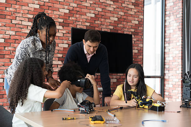 istock Teacher teaching diverse children training and learning robotics technology in classroom at school. Students training AI robot training kit and mechatronics in class 2228142150