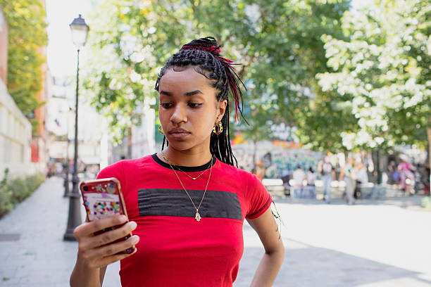 istock Young woman using a smartphone in the city in summer 2228143874
