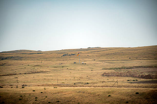 Bowman, SD, US-August 22, 2024: Small white oil pump in grassy field.