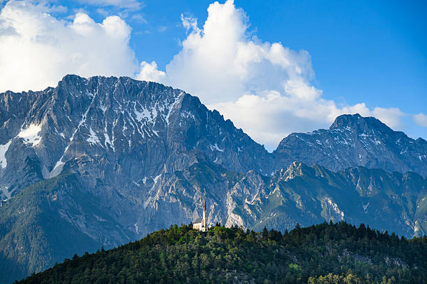 The church Maria Locherboden on a hill in Tyrol and the Austrian Alps in the background