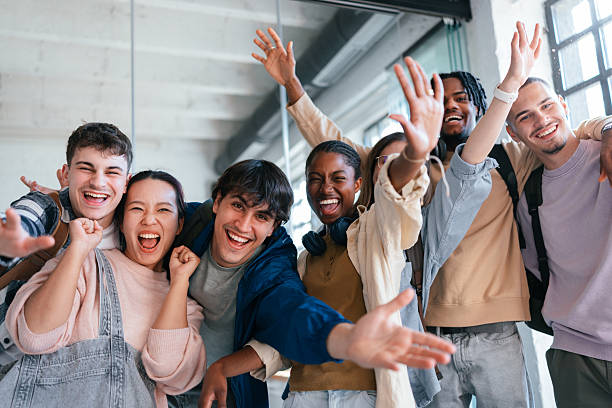 Group of Happy Students Celebrating Together in a Modern Interior