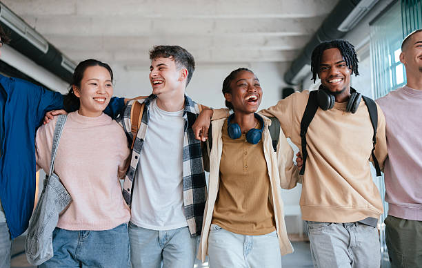 istock Group of Happy Students Laughing and Bonding Together in a Bright Classroom 2228146098