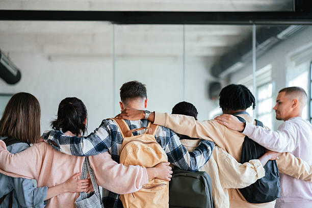istock Group of Students Embracing Together in a Supportive Team Environment 2228146101