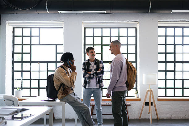 istock Group of Students Socializing Inside a Bright and Modern Classroom 2228146110