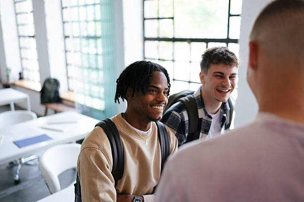 istock Group of Friends Smiling and Engaging in a Bright Classroom Setting 2228146112