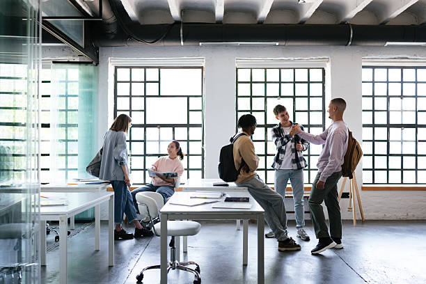 istock Group Of Students Socializing in a Modern Academic Environment 2228146119