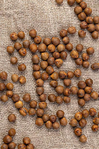 istock Roasted chickpeas are scattered on the table before cooking, fried but not boiled chickpeas are on the table with a tablecloth, close up 2228148887