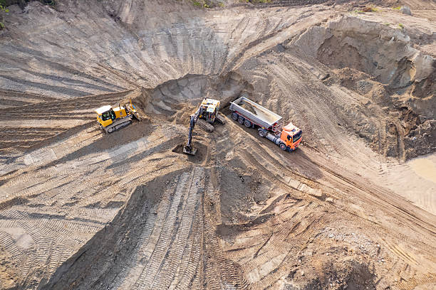 istock aerial view of quarry. excavator loading sand into dump truck 2228150235
