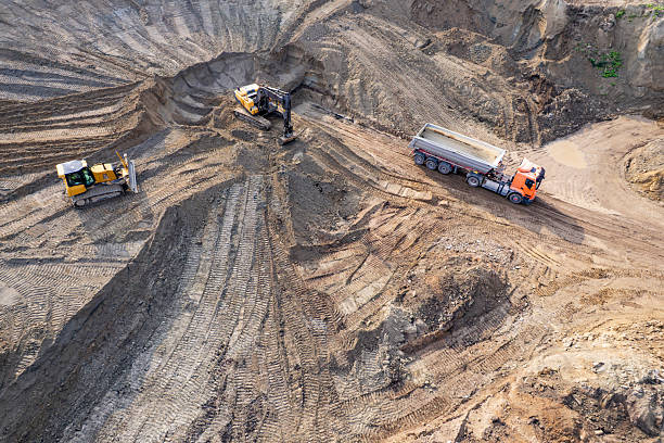 istock aerial view of quarry. excavator loading sand into dump truck 2228150351