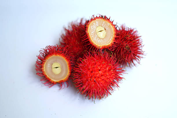 one bunch of fresh Nephelium lappaceum fruit on a black table