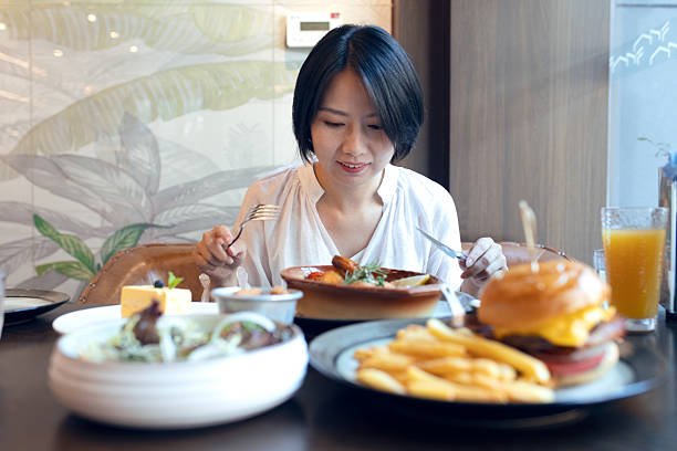 istock An Asian woman dining in a restaurant 2228154269