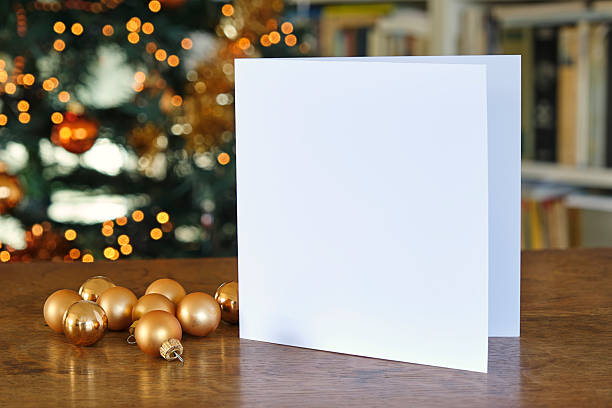 istock Standing blank greeting card mockup in front of a christmas tree 2228154429