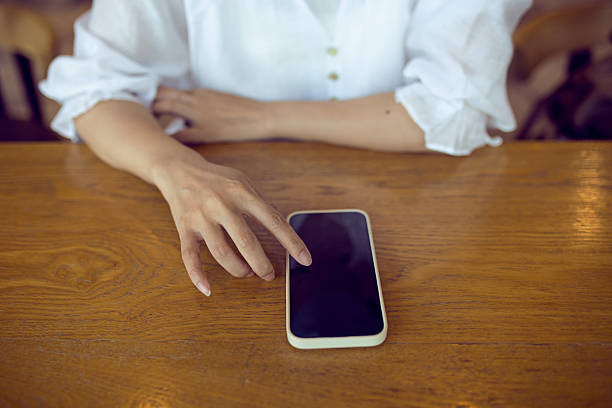 istock High angle view of woman using mobile phone 2228155720