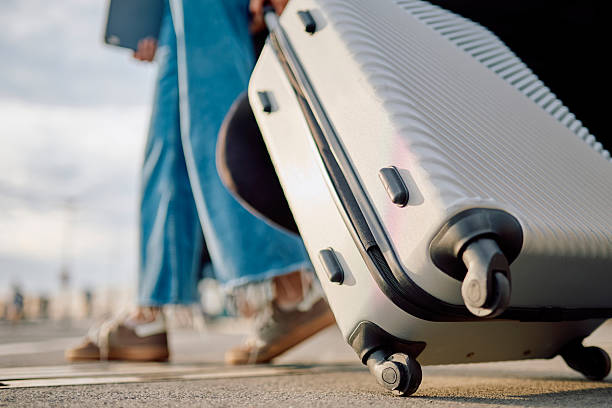 istock Traveler pulling suitcase at the airport 2228157281