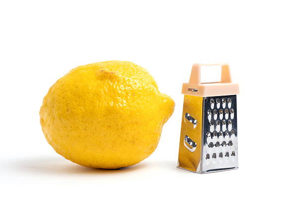 istock Lemon and grater on a white background. Dining hall cooking tool. 2228157541