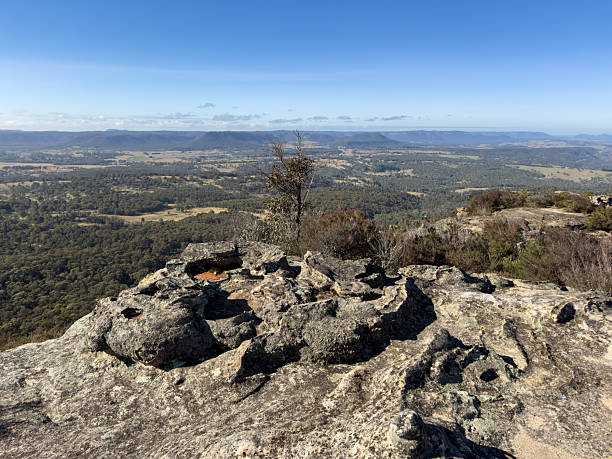 istock Rocky outcrop overlooking bushland and distant hills. 2228158972