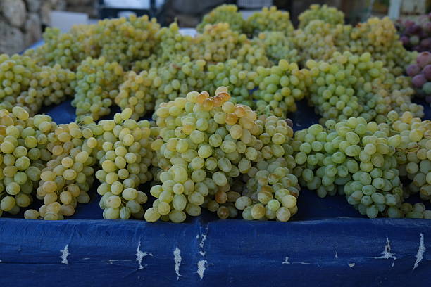 Green grapes for sale in the marketplace, summer fruit, sweet fruit, business for local farmers