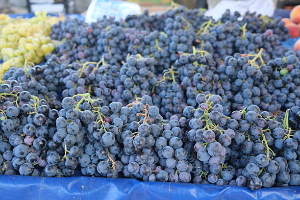 Black grapes for sale in the marketplace, summer fruits, sweet fruits, business for farmers