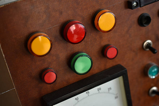 An old control board with a voltmeter, switches and lamps. Electronic control panel with buttons and toggle switches. The old management system.