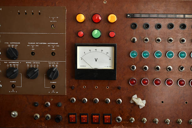 An old control board with a voltmeter, switches and lamps. Electronic control panel with buttons and toggle switches. The old management system.