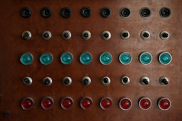 An old control board with a voltmeter, switches and lamps. Electronic control panel with buttons and toggle switches. The old management system.