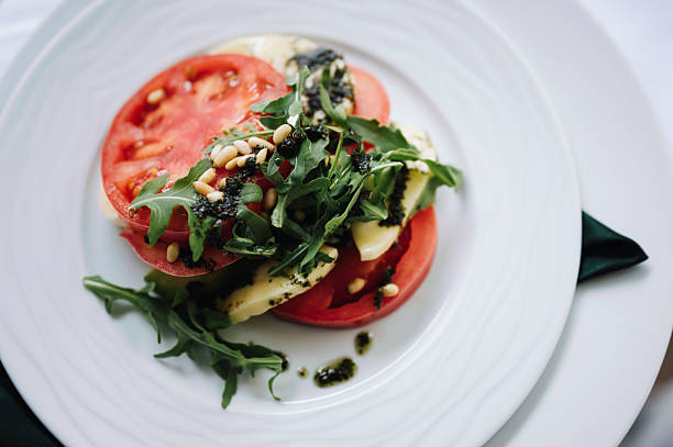 Tasty salad with tomato, mozzarella, arugula salad.