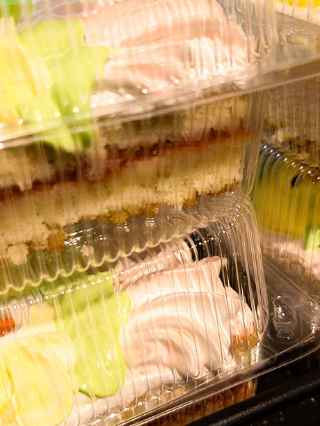 istock Delicious layered cakes in clear plastic containers displayed at a bakery in the afternoon on a sunny day, tempting customers with various flavors and colorful designs 2228168390