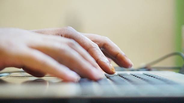 istock Close-up of human hands typing on a laptop keyboard, representing digital communication and modern technology 2228170233