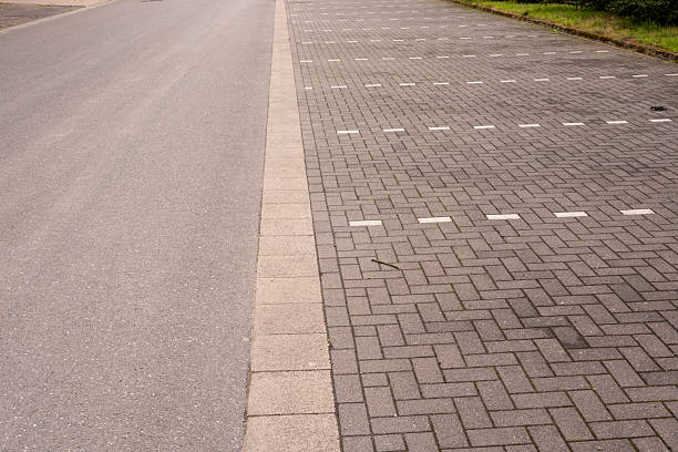 istock Empty parking lot with white markings next to asphalt road 2228171185