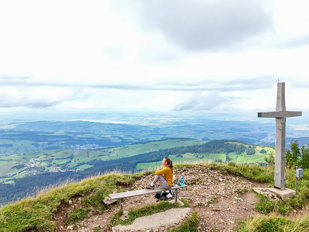 The backpack is lying on a bench in the Alpine mountains