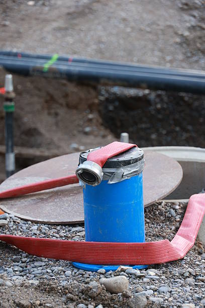 istock Blue pipe with a red hose on top of it 2228174024
