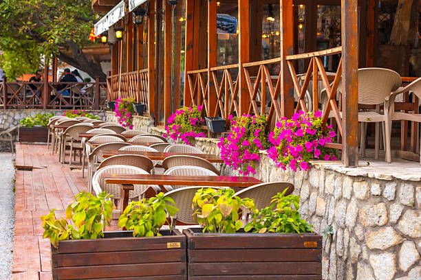 Ohrid, North Macedonia - September 24, 2023: Flowers decorated summer restaurant terrace with lake view