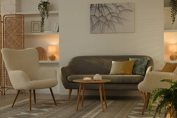 istock Beautiful armchairs, sofa and coffee table in living room. Interior design 2228177042
