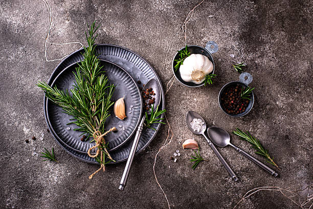 Rosemary, garlic, salt and pepper. Culinary background.