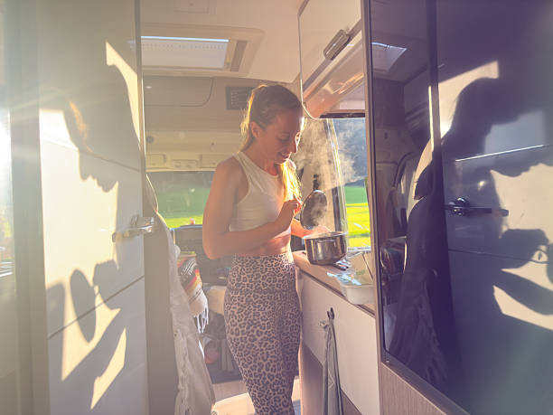 istock Woman Preparing Food Inside Camper Van 2228179657