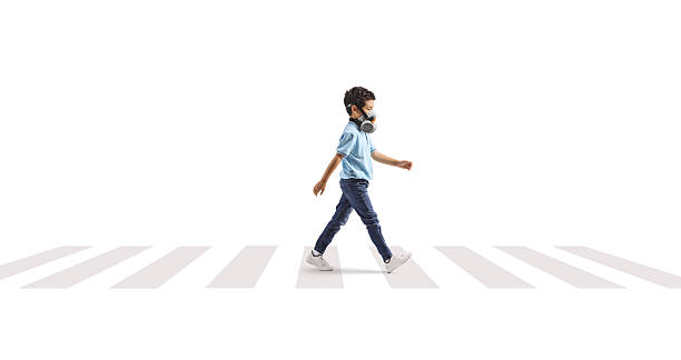 istock Boy with a gas mask at a pedestrian crossing 2228180948