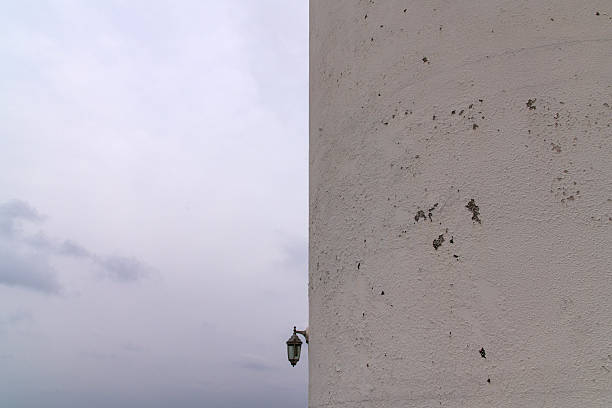 Manavgat harbour entrance and lighthouse with man fishing, bad weather