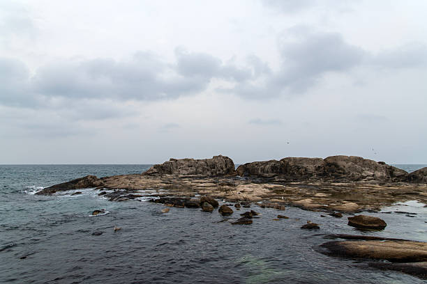 istock rocks and clouds on the sea 2228182358