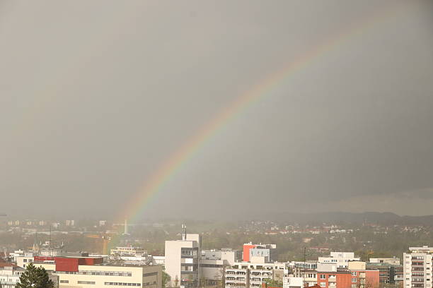 istock A rainbow is seen in the sky above a city 2228182491