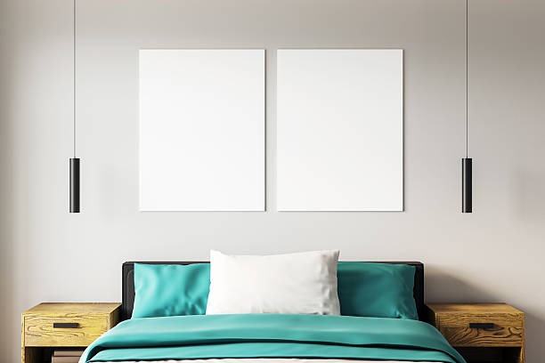 istock Two vertical blank posters above a modern bed in a contemporary bedroom with teal bedding, wooden nightstands, and pendant lights. 3D Rendering 2228184102