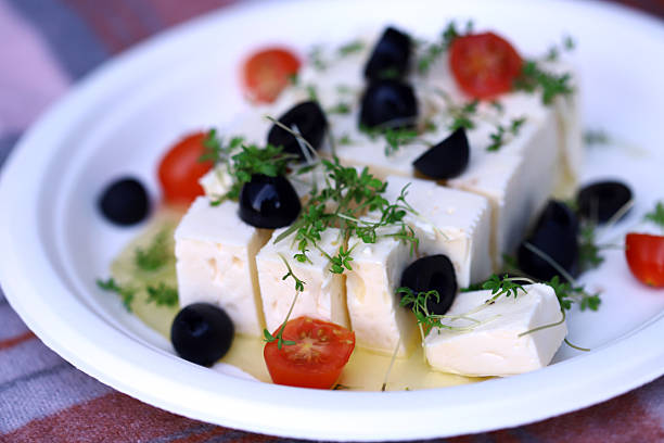 istock Feta cheese with olives, tomatoes and microgreens. 2228185362