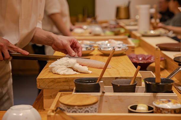 istock a chef cutting raw fish at a Japanese restaurant 2228188492